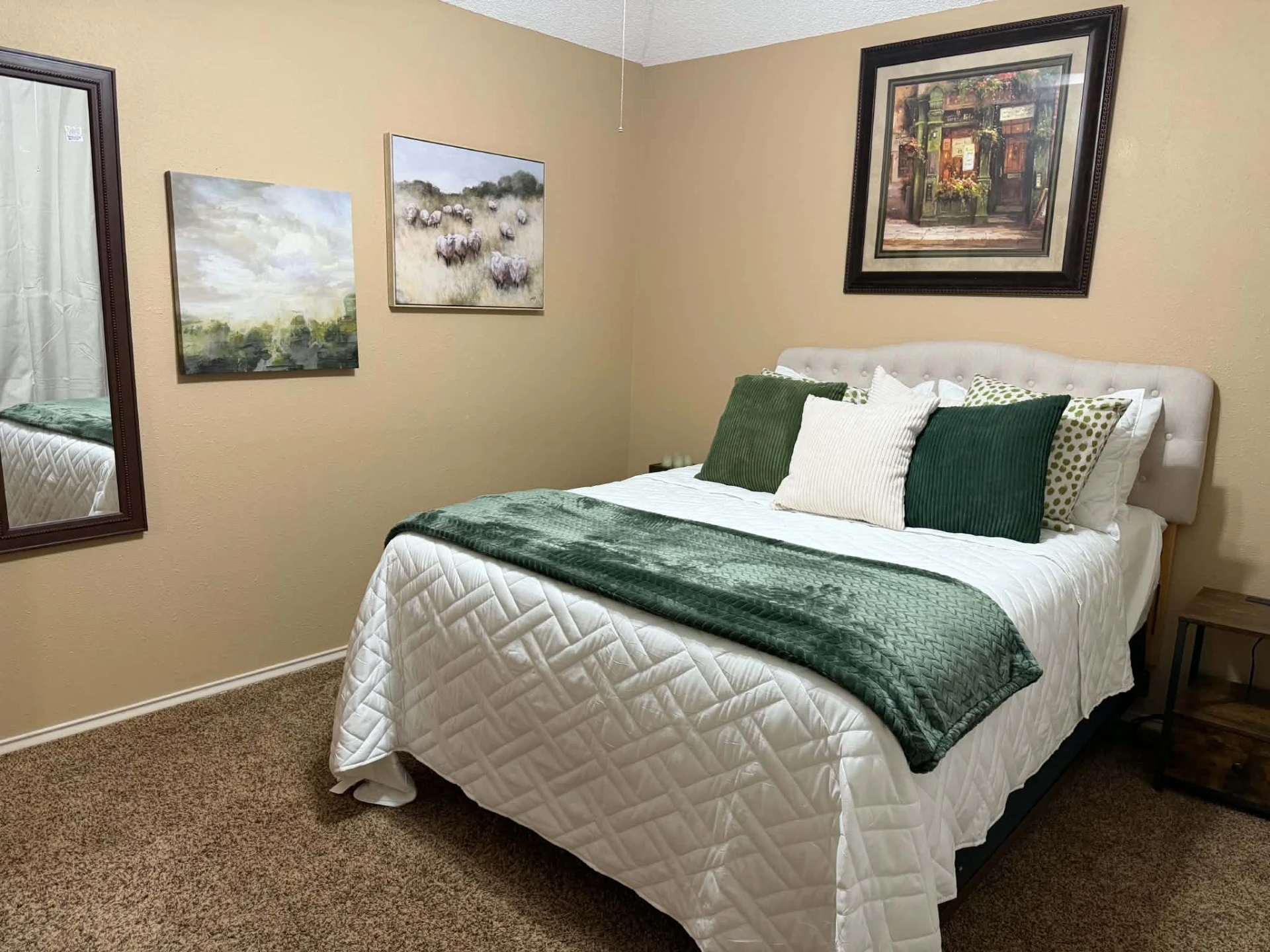 Bedroom 2 — queen bed with green accents seen from the doorway